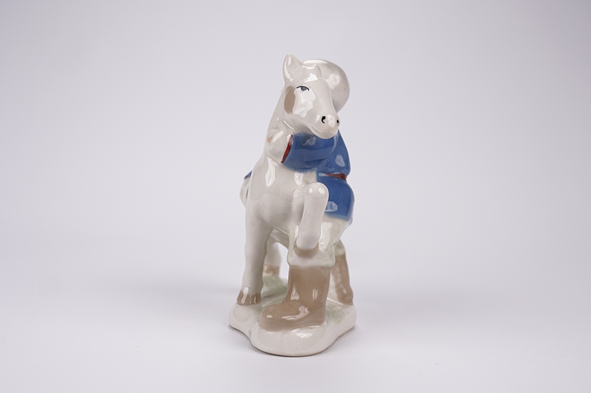 Porcelain figurine «Boy hugging horse».